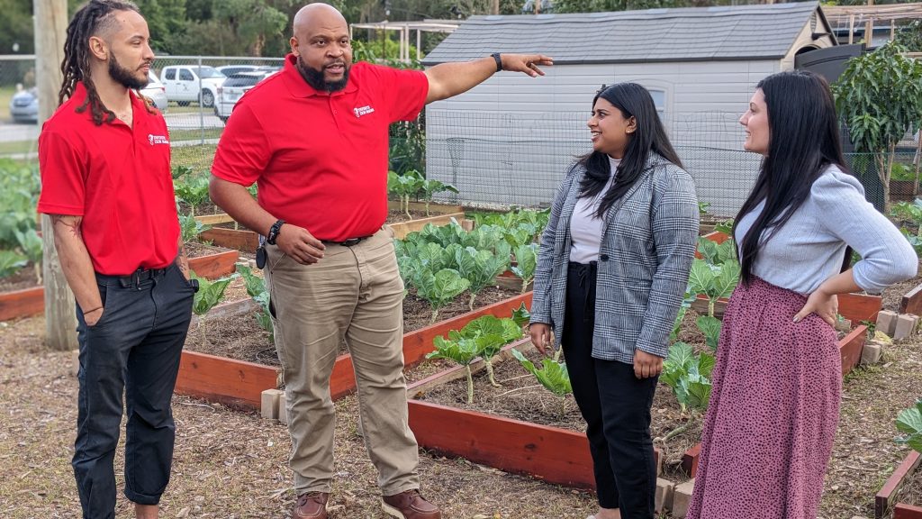 people standing in urban garden in Orlando, Florida talking