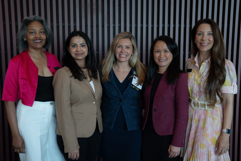 100 Women Strong members pose for a picture at the 2025 Elevate Summit; women's giving circle